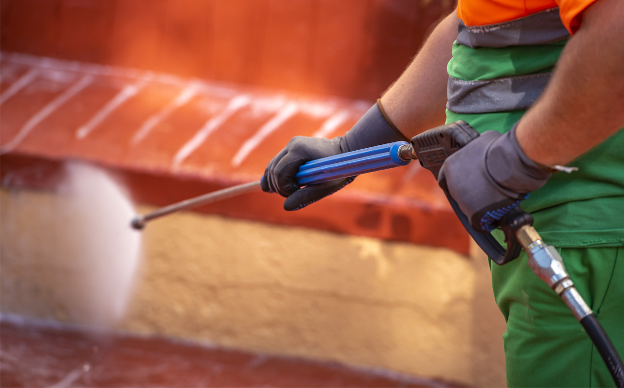 Man Demonstrating the use of a pressure washing wand in Troy, NY