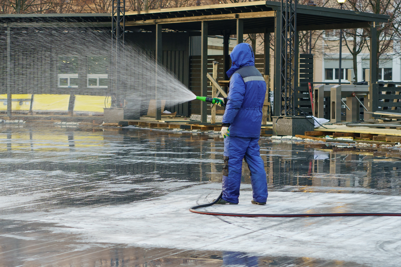 Man pressure washing a commercial plaza and storefront in Hudson NY