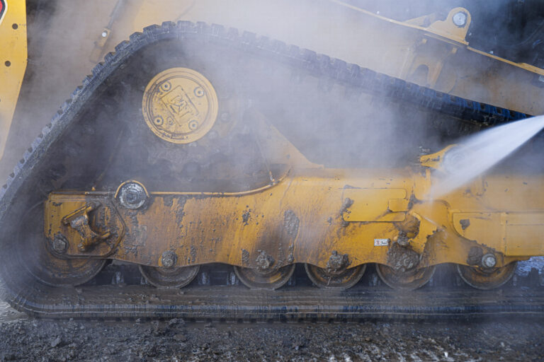 Professional skid steer washing in Saratoga Springs, NY during heavy equipment cleaning