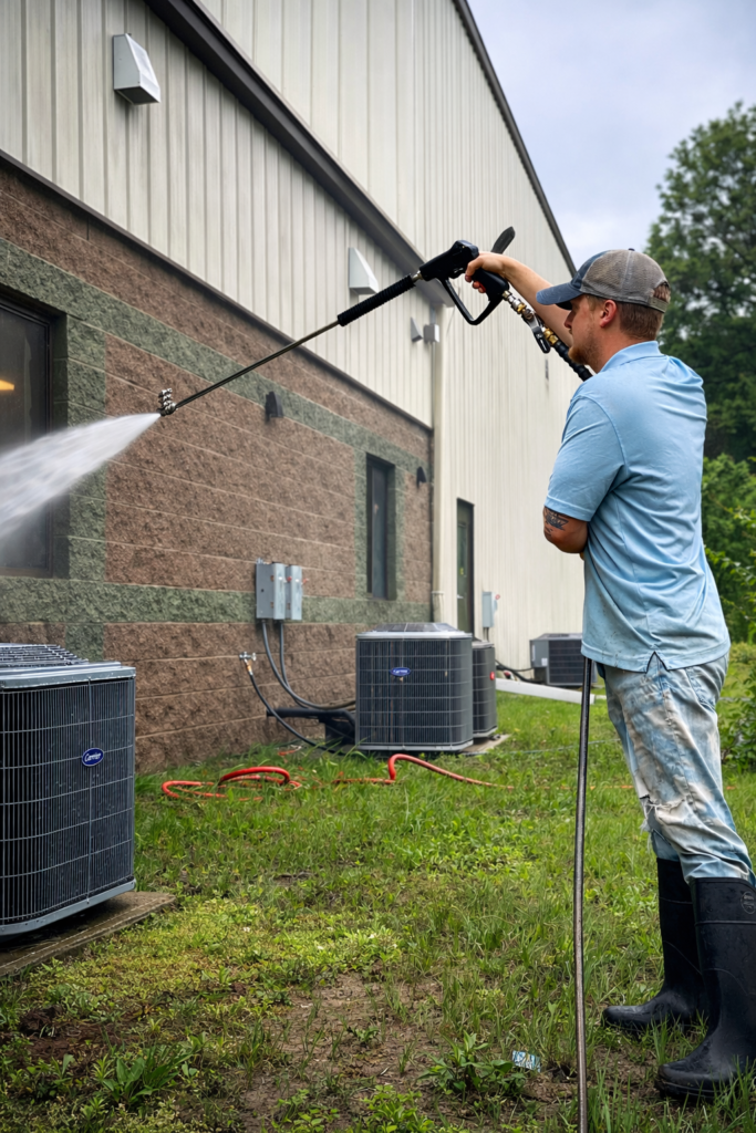 Griffin Power Washing owner pressure washing commercial building in clifton park new york.